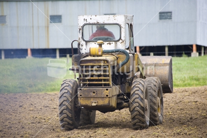 An earth mover driving off