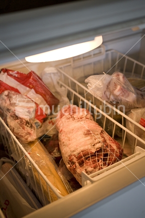 A deep freezer full of frozen meat and food