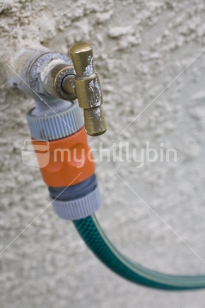 A garden hose attached to a tap