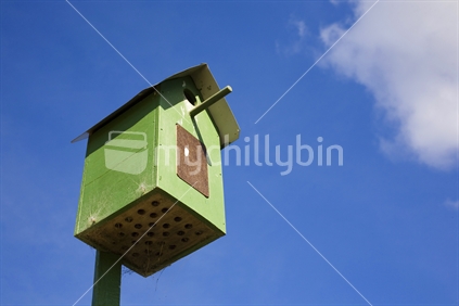 A green birdhouse