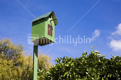 A green garden birdhouse