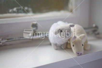 Babies soft toys on a white windowsill