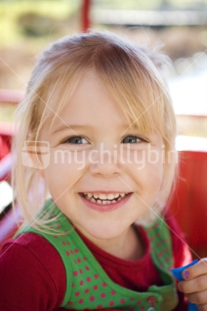Cute blonde girl with a big grin
