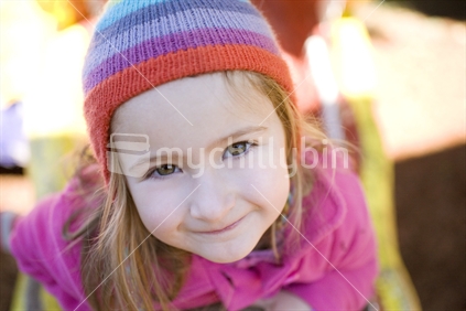 A young girl looking up to camera