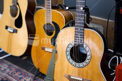 A row of guitars at a busking stand