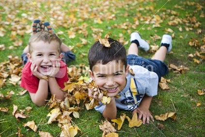 2 brothers lying in autumn leaves