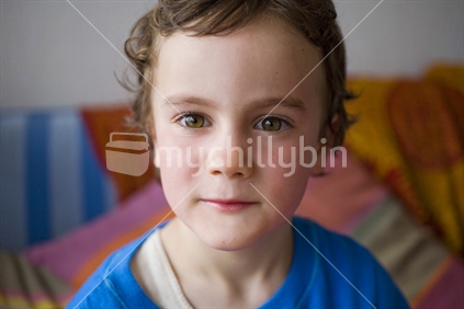 A young boy front on with interesting expression