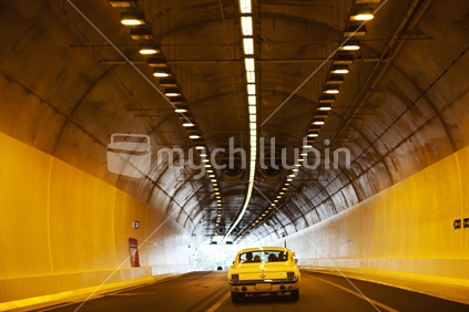 A car driving through the tunnel north of Auckland, New Zealand