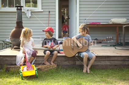 Kids playing on the deck in summer, New Zealand