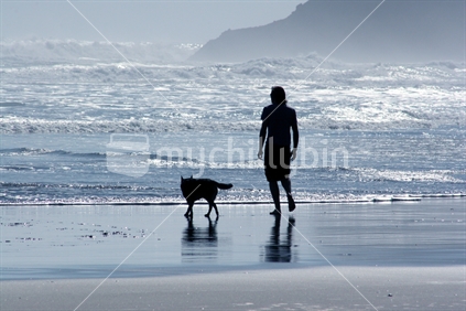 man and his dog on the beach