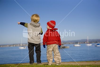 Two young boys looking over the harbour