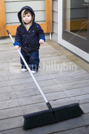 young boy sweeping
