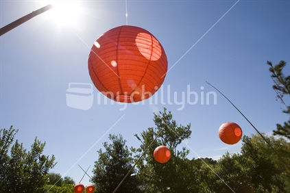 Red lanterns hanging in the sun