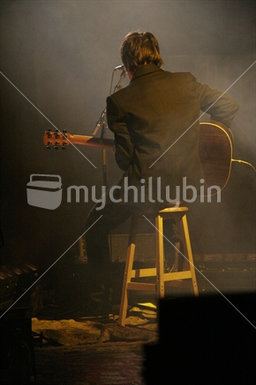 playing guitar on stage