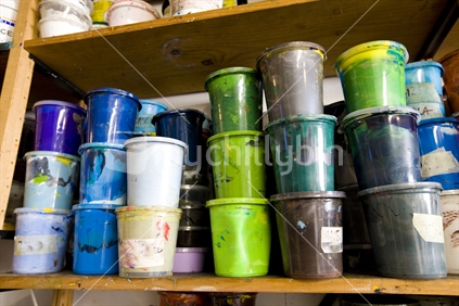 plastic containers of coloured paint