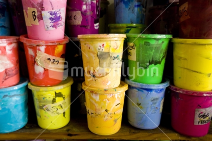 plastic containers of coloured paint