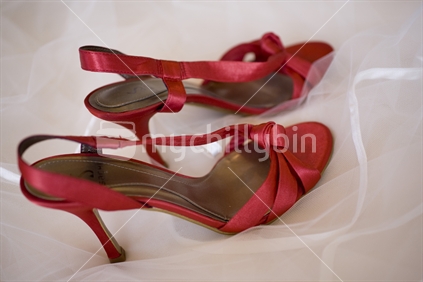 A pair of red satin heels