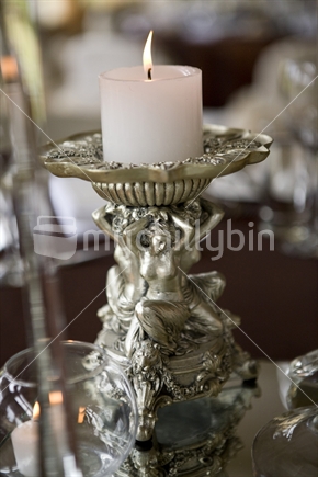 Candle and holder decorated with nymphs and cherubs