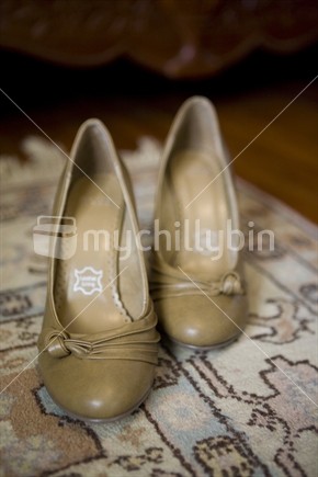 a pair of tan coloured leather heels