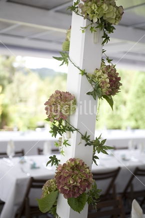 Decorative hydrangeas around a veranda post