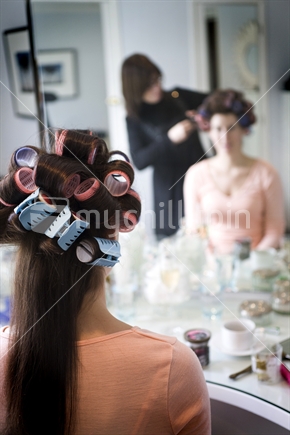 A girl has her hair in rollers