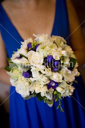 A bridesmaid holds a bouquet of flowers