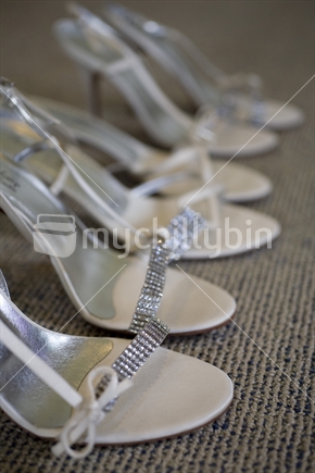 A row of white and diamante wedding shoes