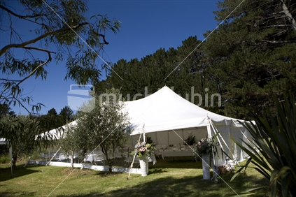 A white marquee in the bush on a beautiful sunny day