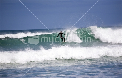 Surfing at Piha beach
