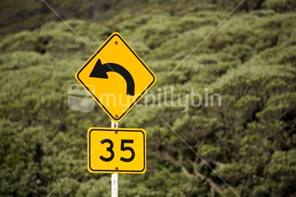 35km road sign at a corner at Piha Beach, Waitakeres