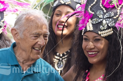 Smiling man and Cook Island dancers at the Pasifika festival. 