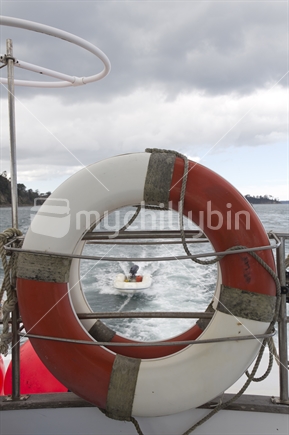 Life ring tethered to deck of a boat. 