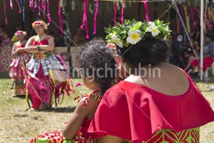 Tuvaluan mother and daughter watching traditional dancers at Pasifika Festival