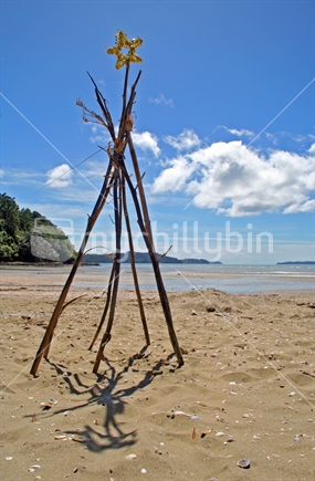 Flax stick Christmas tree on the beach
