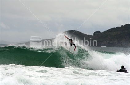Surfer performing a cutback in the wave