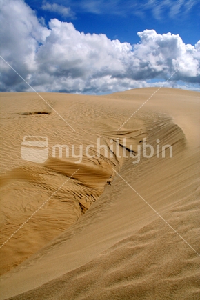 Contrasts of dunes against a dramatic clouds