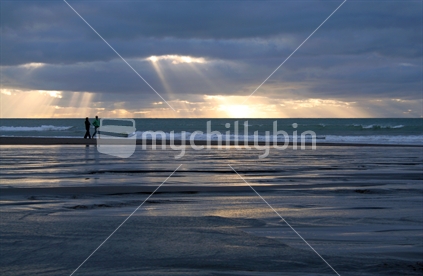 A couple out walking on Oakura Beach, New Plymouth, New Zealand
