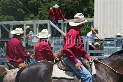Three cowboys on horseback