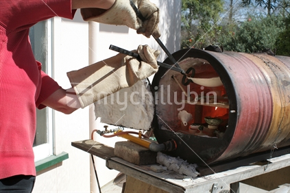 Removing fired pots from a Raku Kiln