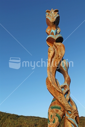 Wooden Maori carving stands guardian of Omaha Beach, New Zealand