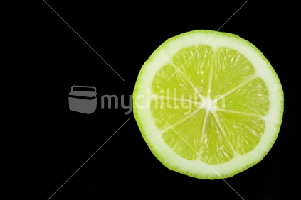 Slice of Lime with black background and copy space.