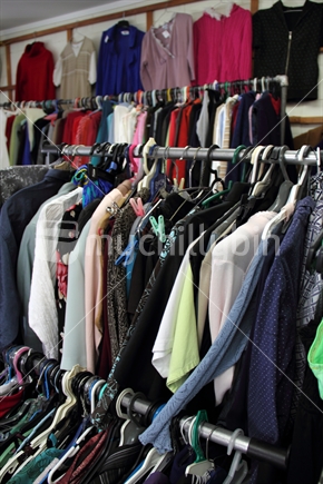 Rack of second hand clothing for sale in opportunity or thrift shop. 