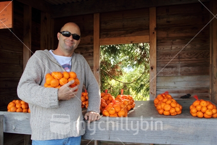 Man shopping at a roadside fruit stall. 