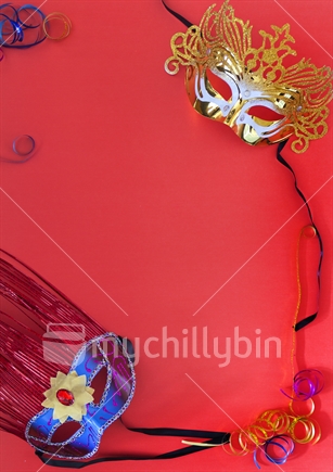 Two carnival masks on a red background with copy space for your own words. Could be used as poster, invitation etc.