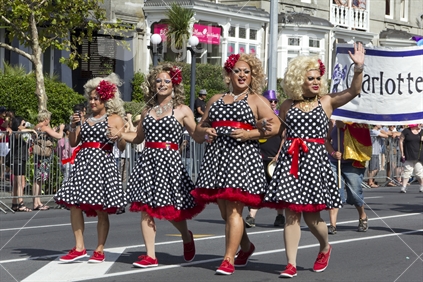 Group of drag queens marching down Ponsonby road in Gay Pride parade. 