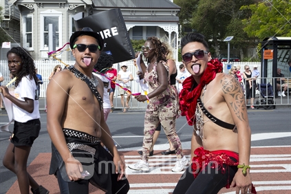 Two young Maori men stick out their tongues, Auckland gay pride parade.