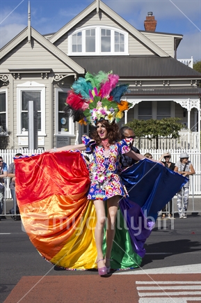 Drag queen in rainbow dress, at gay pride festival, outside the Allcare Family Medical Centre. 