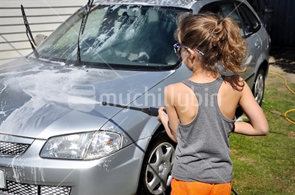 Girl washes a car