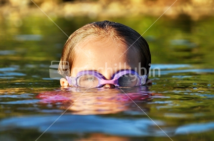Girl swimming (selective focus and some motion blur)