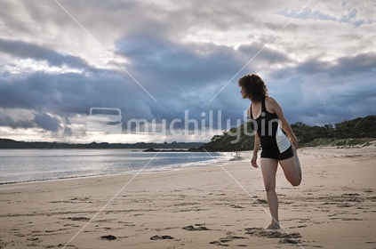 Stretching on the beach (Selective Focus, Low Light Image)